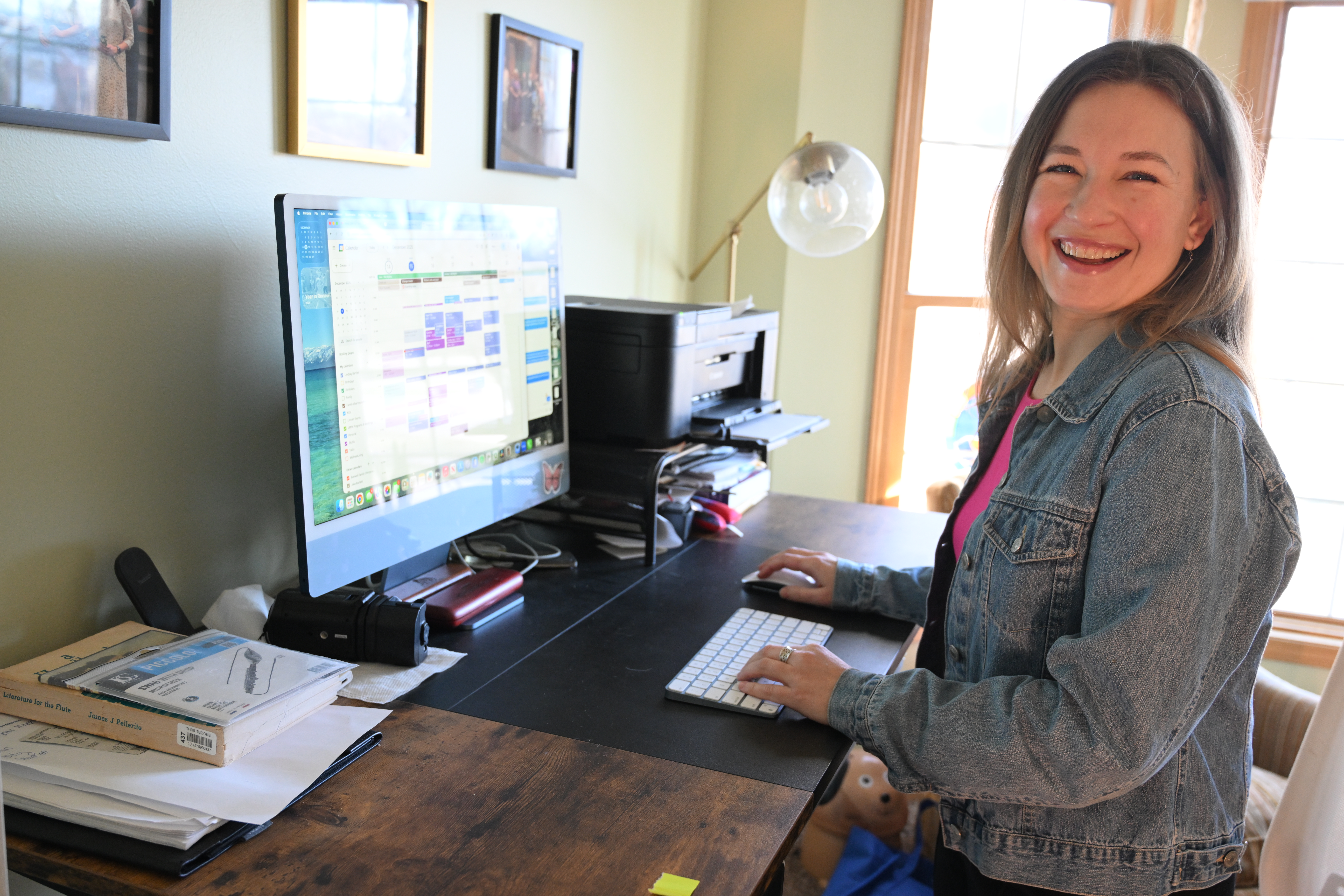 Lindsay laughing at her overwhelming calendar in her home studio. Photo by AVDude.
